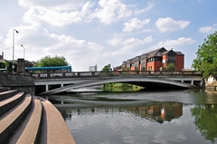 A view of the River Derwent and Exeter Bridge at Derby. There are tall buildings in the background. Link to Bridges Gallery.