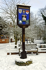 A wintry scene of the village sign at Rolleston on Dove, Staffordshire, England. Link to Signs Gallery.