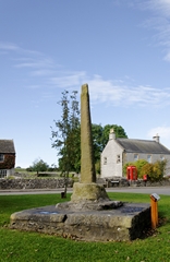 A view of the Village Cross on the green at Monyash in Derbyshire, England. Link to Crosses Gallery.